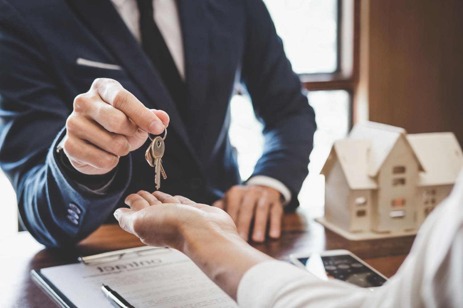 owner giving keys to buyer
