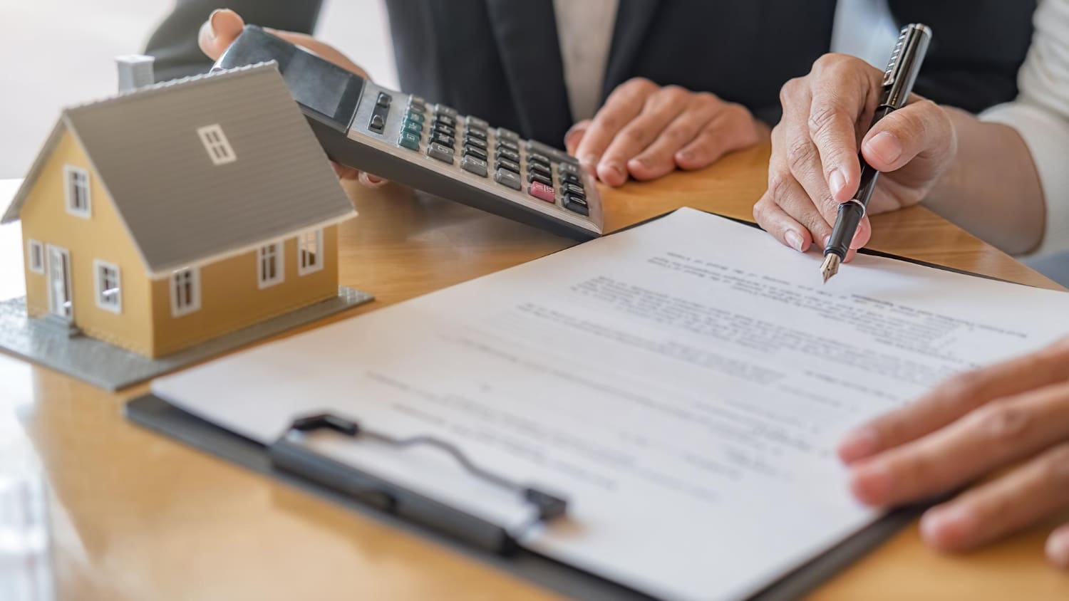 woman signing contract and doing paperwork